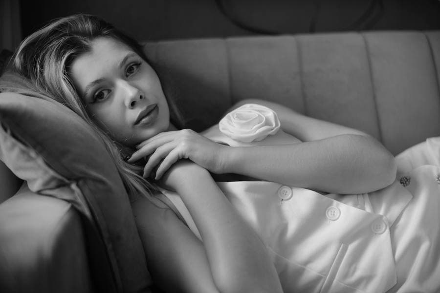 A woman lying back, caught mid-thought.